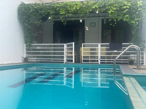 a swimming pool with a stairway leading to a building at Surveyor's Residence Bungalow in Kandy