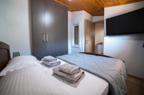 a bedroom with two beds with towels on them at Archontiko Adamou in Kyperounda