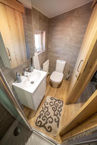 a bathroom with a white sink and a toilet at Archontiko Adamou in Kyperounda