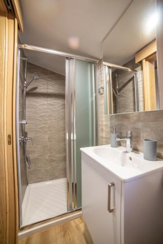 a bathroom with a shower and a sink and a toilet at Archontiko Adamou in Kyperounda