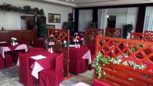 a dining room with red tables and chairs with red table cloth at ABC Hotel Nitra in Nitra