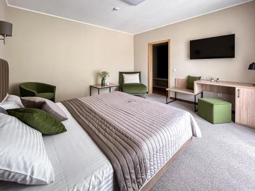 a hotel room with a bed and a television at Blueberryhouse in Bukovel