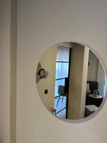 a round mirror on the wall of a room at METEORITO central apartment in Kalabaka
