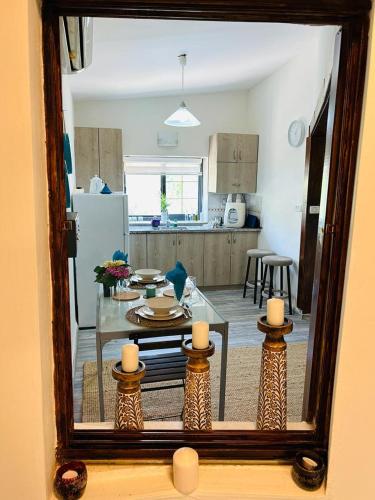 a living room with a table and a kitchen at דרך עצי הזית - through the olive tree in Neve Ilan