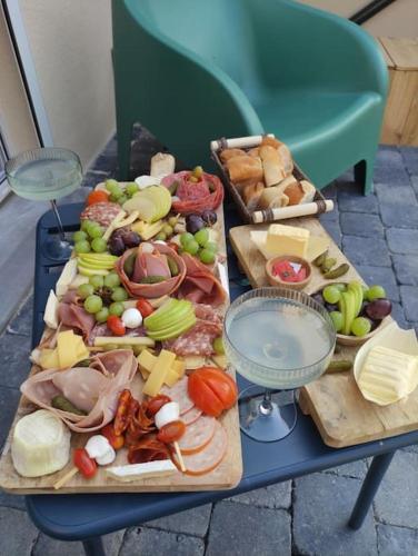 a table full of different types of food on cutting boards at L'Évasion des Sens - Spa Sauna Hammam Jacuzzi in Bray-sur-Somme