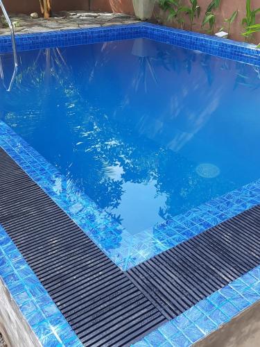 a blue swimming pool with a grate in the water at Lake View Villa in Mirissa