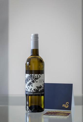 a bottle of wine sitting on top of a table at Bay Point Hideaway in the Woods in Beulah