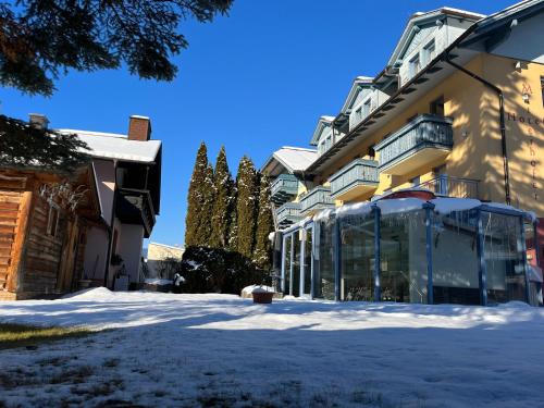 a building with snow in front of it at B&B das Alpinhotel Maistatt in Schladming