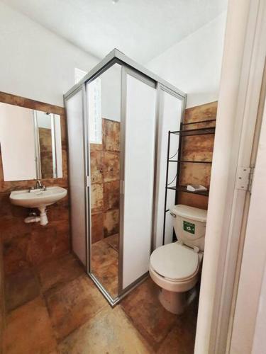 a bathroom with a toilet and a sink at Casa Canseco in Oaxaca City