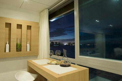 a room with a window with wine glasses and a table at Beach Front Penthouse - San Juan - A 604 in San Juan