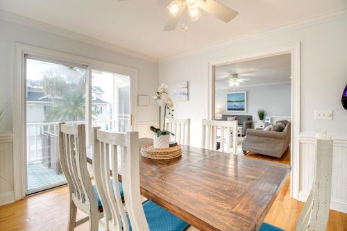 a dining room with a wooden table and chairs at Elegant Tybee Island Townhome, Steps to Beach in Tybee Island