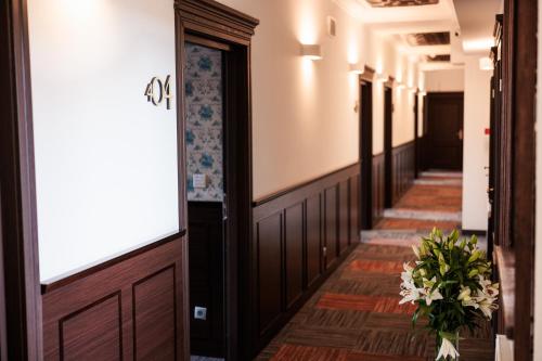 a hallway with doors and a potted plant on the floor at Palazzo Rosso Old Town in Poznań