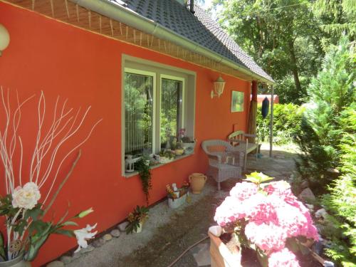 an orange house with flowers in front of it at Ferienhaus Zingst MinHus in Zingst