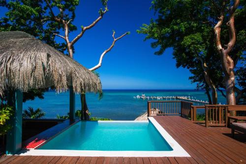 a swimming pool with a view of the ocean at Casa de Suenos Home in Sandy Bay