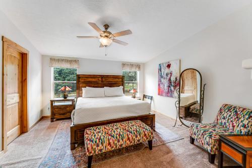 a bedroom with a bed and a couch and a ceiling fan at Lazy K on Peaceful Bay - Ranch House in Lakeside