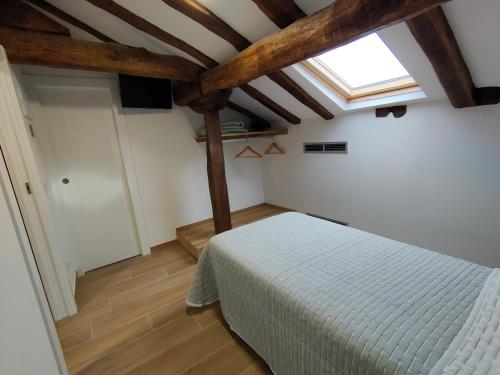 a bedroom with a bed and a skylight at El Pino in Penagos