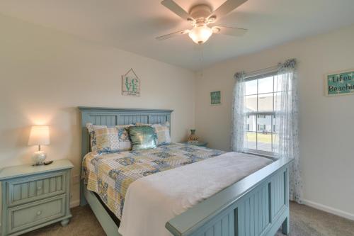a bedroom with a bed with a ceiling fan and a window at Gulf Shores Condo with Pool Access, 5 Mi to Beach! in Gulf Shores