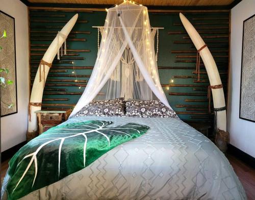 a bedroom with a bed with a canopy at Cozy AF Jungle-House Hideaway in Tampa