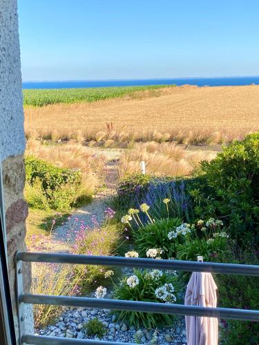 a balcony with a view of a field of flowers at La Grange Neuve in Plougonvelin