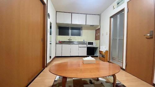 a small kitchen with a table in a room at Takamatsu-205 in Takamatsu