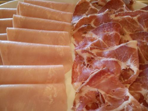 a pile of bacon and cheese on a plate at Country House La Perla del Sile in Sant'Elena di Silea
