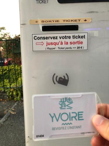 a person holding a sign on a gas pump at Cocon au cœur de Yvoire avec parking gratuit in Yvoire