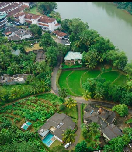 an aerial view of a house next to a river at Surveyor's Residence Bungalow in Kandy