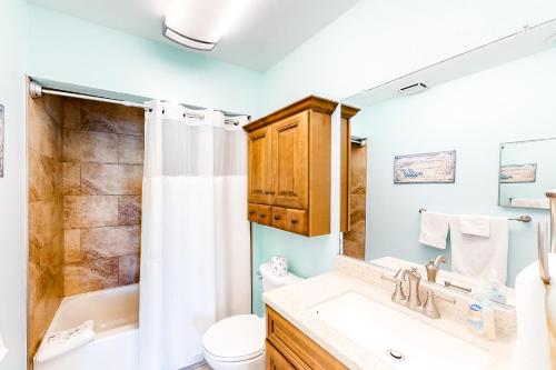 a bathroom with a sink and a toilet and a shower at Sea Breeze 705 in St Pete Beach