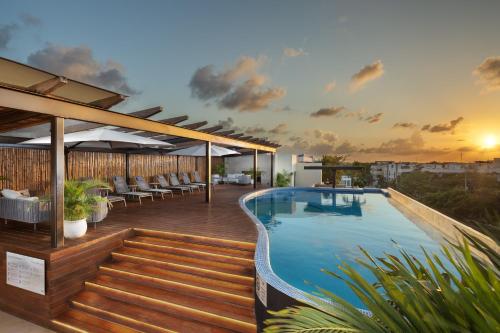 a swimming pool on the roof of a building at Cacao Tulum departamentos in Tulum
