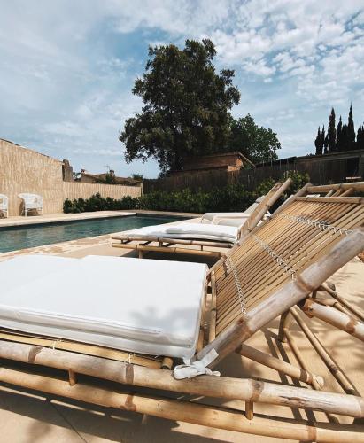 a group of lounge chairs sitting next to a pool at Mas Ferran Adults Only in Pals