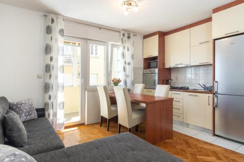 cocina y comedor con mesa y sillas en Apartment Sunce 1-bedroom apartment in Split en Split