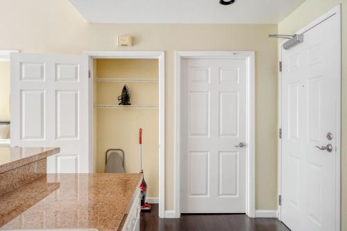a kitchen with two white doors and a sink at San Bruno 2br w pool spa gym nr groceries SFO-1398 in San Bruno
