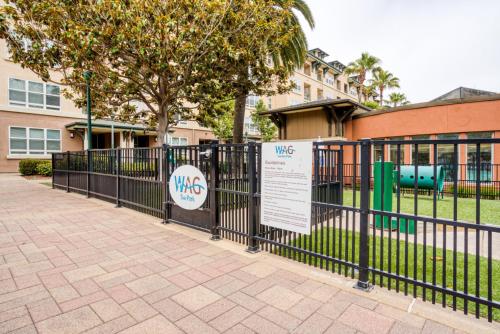 a black fence with a sign in front of a building at San Bruno 2br w pool spa gym nr groceries SFO-1398 in San Bruno
