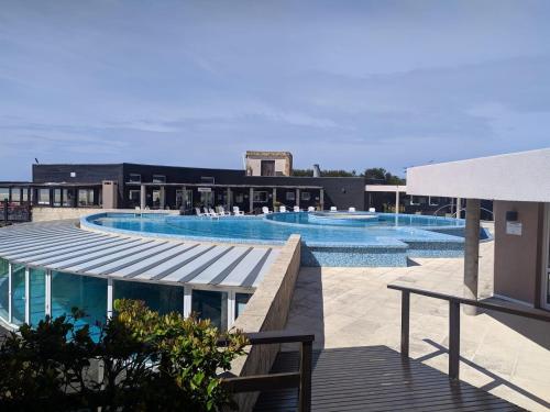 a large swimming pool with two swimming pools at LINDABAYPLAYA STUDIO in Mar de las Pampas