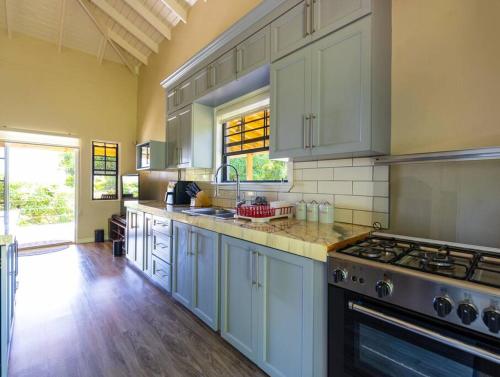 a large kitchen with white cabinets and a stove at Natural Mystic 