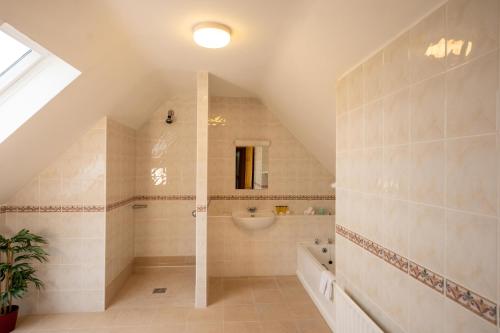 a bathroom with a shower and a sink at Waterfront House & Restaurant in Enniscrone