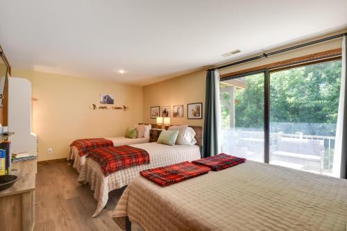 two beds in a room with a window at Galena Townhome with Community Perks! in Galena
