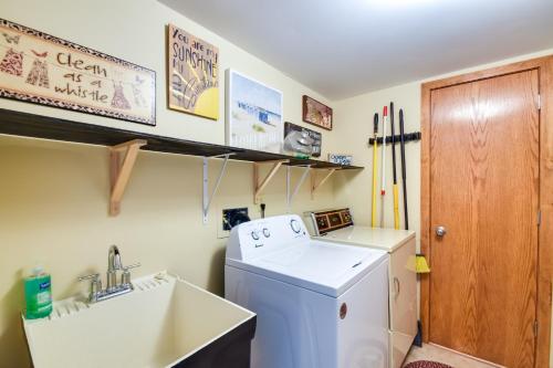 a small kitchen with a washing machine and a sink at Galena Townhome with Community Perks! in Galena