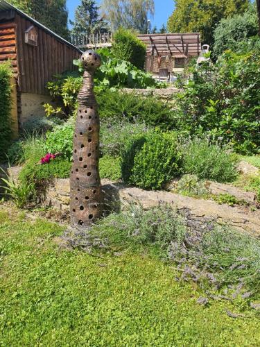 a stone tower in the middle of a garden at Penzión Eva in Stará Voda