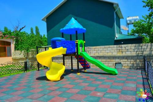 a playground with a slide and an umbrella at SEA STAR HOTEL in Şimal