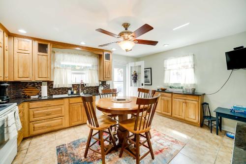 a kitchen with a table and chairs and a ceiling fan at Walk to Walnut St Shadyside House with Deck in Pittsburgh