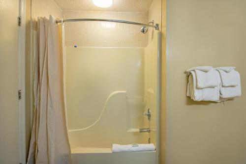 a bathroom with a shower and a toilet with towels at Massanuttens Shenandoah Villas by TripForth in McGaheysville