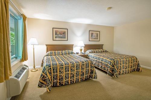 a hotel room with two beds and a window at Massanuttens Shenandoah Villas by TripForth in McGaheysville
