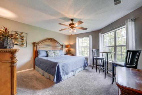 a bedroom with a bed and a ceiling fan at Branson Condo Ideally Located 3 Miles to Downtown! in Branson