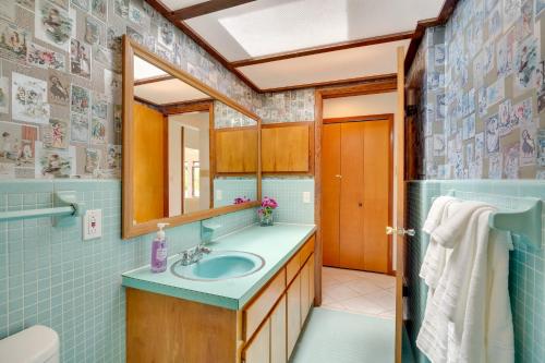 a bathroom with a sink and a mirror at Cocoa Beach House on Banana River Walk to Ocean! in Cocoa Beach