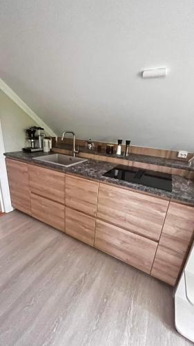 a kitchen with a sink and a counter top at Bo i historisk bygning, kort vei til sentrum in Trondheim