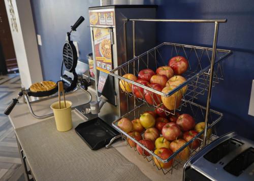 a bunch of apples in a basket on a counter at Airport Inn in Nederland