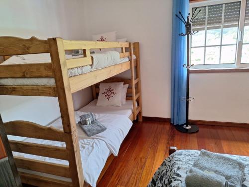 a bedroom with two bunk beds and a window at Martins House in Arouca