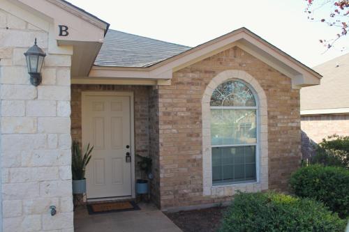 a brick house with a white door at Setting the right vibes. in Killeen