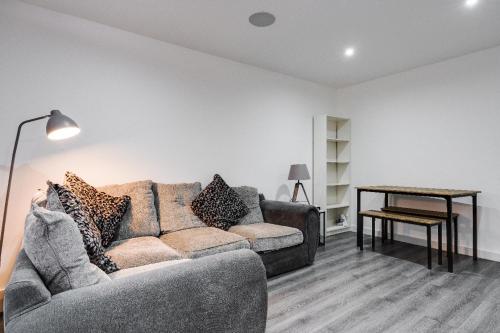 a living room with a couch and a table at 17 cliff st. in Liverpool